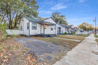 Bungalow featuring a residential view and roof with shingles