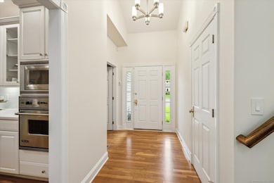 Bright entrance foyer with hardwood floors.