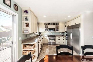 Kitchen opens to dining area w/sliding doors to la