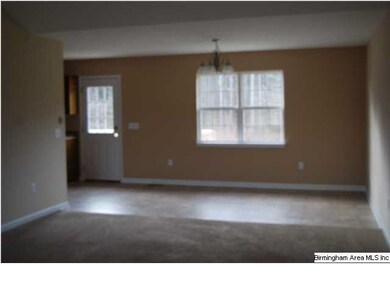Living room looking into eat in kitchen