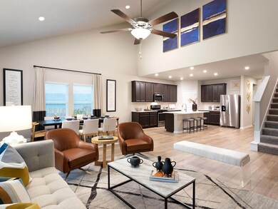 Living room with high vaulted ceiling, light wood