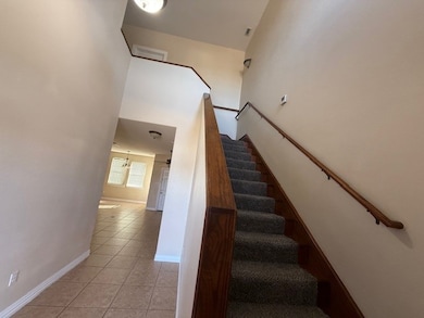 Stairs featuring tile patterned flooring and baseboards