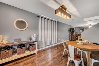 Dining room featuring ceiling fan and dark hardwoo