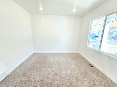Carpeted empty room featuring baseboards
