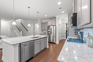 Kitchen with sink, tasteful backsplash, pendant li