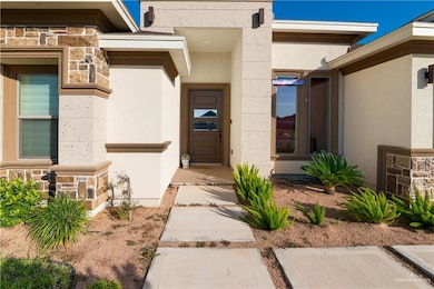 View of exterior entry featuring stone siding and stucco siding