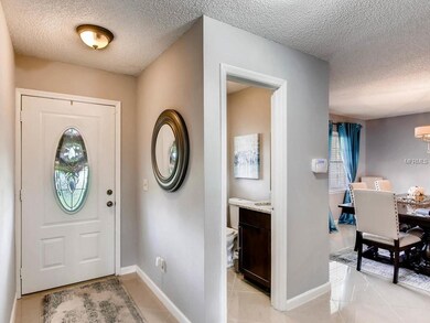 Facing the front door, half bath and to the right 