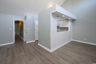 Unfurnished room with dark hardwood / wood-style f