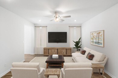 Living area with ceiling fan, wood finished floor