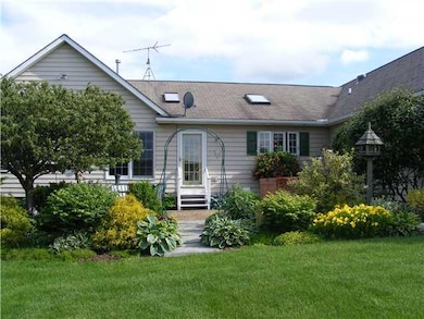 Exterior Back. Patio Area with lush landscape.