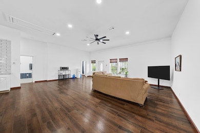 Living area with recessed lighting, dark wood fini