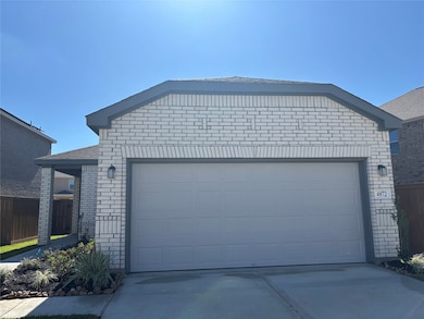 Modern single-story home with a light brick exterior, two-car garage, and neatly landscaped front yard. Ideal for those seeking a contemporary and low-maintenance residence.