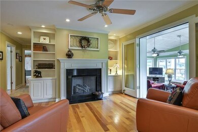Enjoy sitting by the fire in this den or keeping room.  Adjacent to the kitchen, the glow of the fire can also be enjoyed by the owner as they prepare a meal.  Fireplace has gas logs, with built-in bookcases and cabinets surrounding the mantle piece.