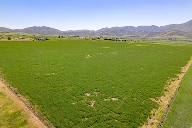 Overview of rural landscape with a pastoral area and a mountain backdrop