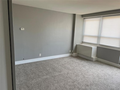 Unfurnished room with baseboards and light carpet
