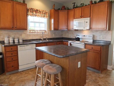 Fully applianced kitchen with island.