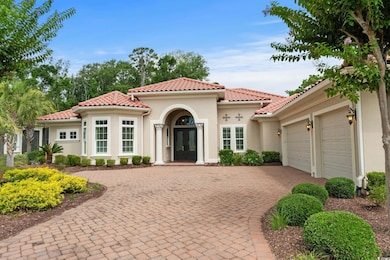 Mediterranean / spanish-style home featuring french doors, decorative driveway, an attached garage, stucco siding, and a tiled roof