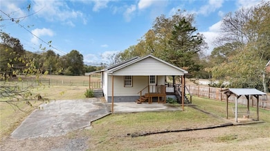 Bungalow-style home with a patio, view of scattered trees, and covered porch
