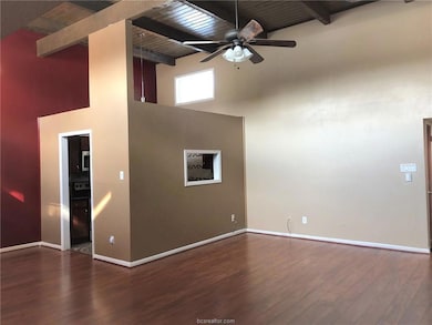 Spare room with high vaulted ceiling, wood finishe