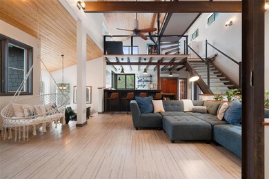 Living area featuring high vaulted ceiling, beam 