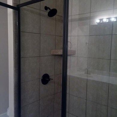 Gorgeous tile work in this step in shower in maste