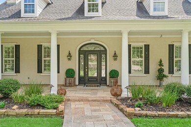 Property entrance featuring a porch, stucco sidin