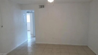 Spare room featuring light tile patterned floors and baseboards