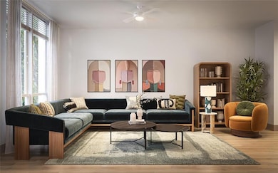 Living room with wood finished floors and ceiling fan