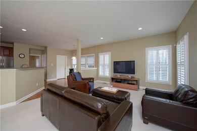Family room with faux wood blinds, recessed lights
