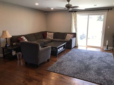 Big living room with maple large plank wood floors