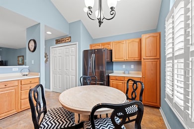 Dining space with a chandelier and vaulted ceiling