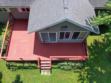 Drone view of the sun room and large wood back yard deck.