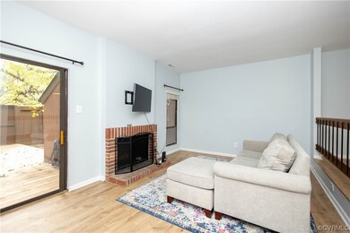 Living room with light hardwood floors and a firep