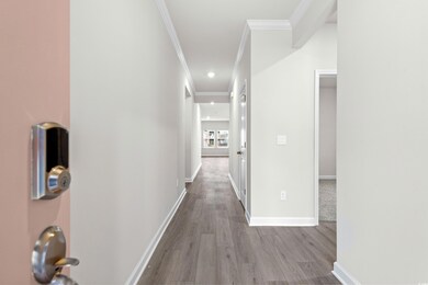Corridor with light wood-type flooring and ornamen
