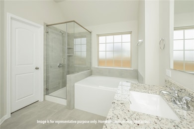 Full bath with a bath, a shower stall, and vanity