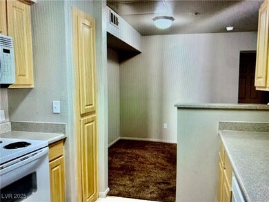 Kitchen with light countertops, light brown cabine