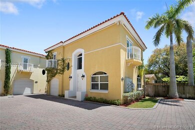 This Coconut Grove Townhome features an attached, one car garage and an adjacent side parking.
