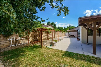 Custom-built grapevine-covered pergola and outdoor seating area