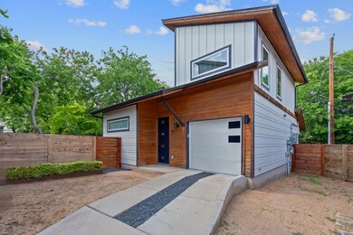 Contemporary house with concrete driveway, fence,