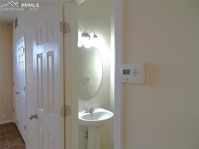 Half bath on the main level with tile patterned fl