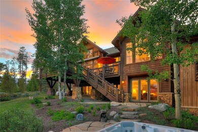 Back of property featuring a deck, stairs, and sto