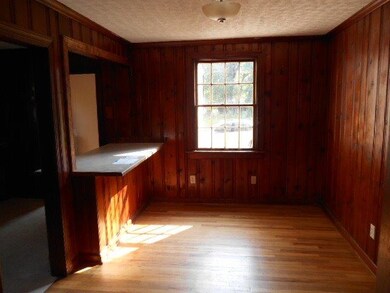 The dining area has beautiful wood floors and a ba