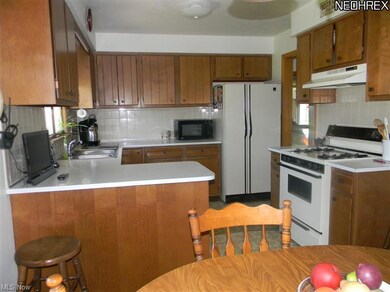 Another view of kitchen.  Stove and refrigerator s