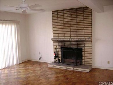 SUBJECT'S LIVING ROOM WITH A BRICK FACED WOOD BURN