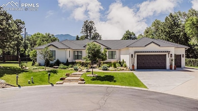 View of front of property featuring a garage, driveway, stucco siding, and a tiled roof