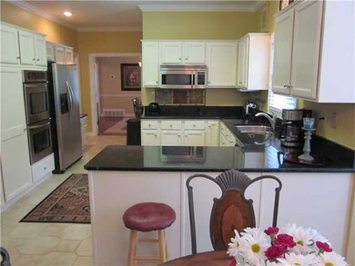 The kitchen also features stainless steel applianc