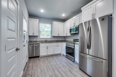 Kitchen with appliances with stainless steel finis
