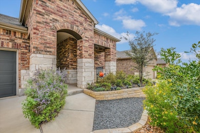 View of exterior entry featuring brick siding and roof with shingles