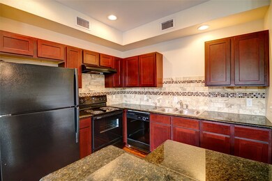 Kitchen with sink, dark stone countertops, backspl