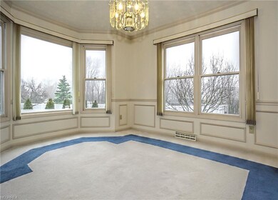 13'  12' dining room with decorative moldings, a north bay window, and large east windows.